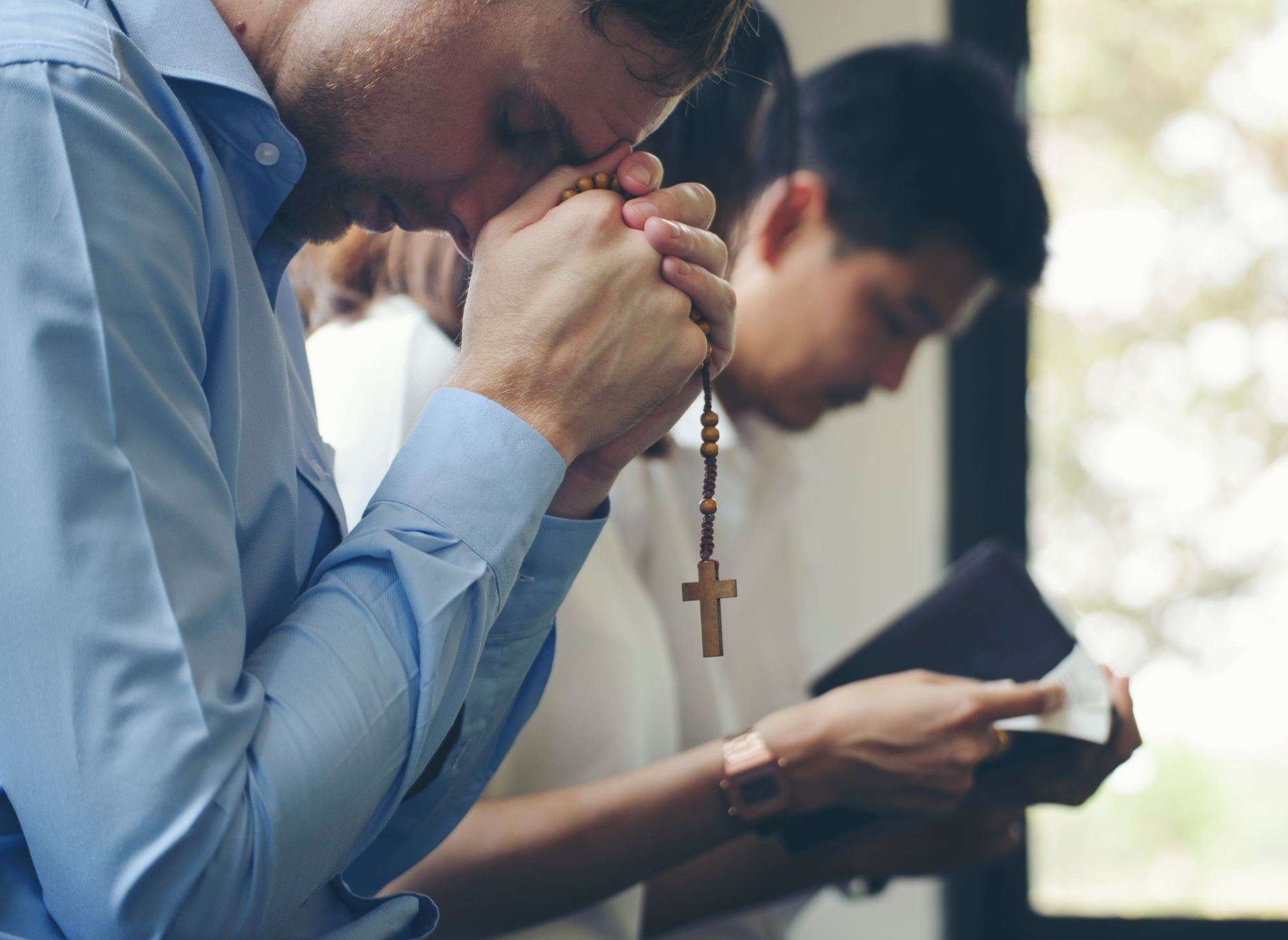 young men of faith praying and reading the Bible